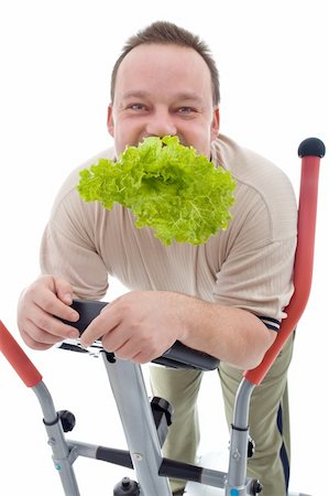 fat man exercising - Power slimming concept - man exercising and eating healthy fresh food, isolated Stock Photo - Budget Royalty-Free & Subscription, Code: 400-04916164