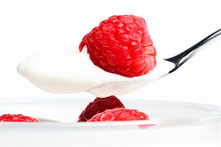 simsearch:824-07586355,k - closeup of a raspberry on a spoon with yogurt over a dessert with raspberries on white background Stock Photo - Budget Royalty-Free & Subscription, Code: 400-04916910