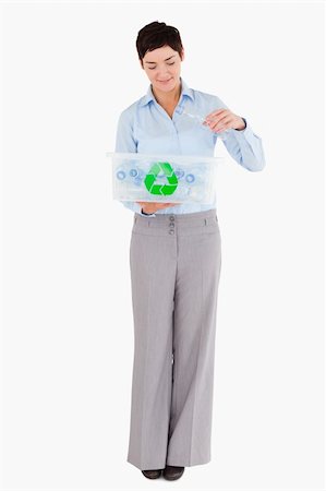 simsearch:400-04917651,k - Woman putting an empty plastic bottle in a recycling box against a white background Stock Photo - Budget Royalty-Free & Subscription, Code: 400-04917665
