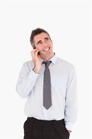 simsearch:400-05145011,k - Portrait of a smiling man making a phone call against a white background Stock Photo - Budget Royalty-Free & Subscription, Code: 400-04918092