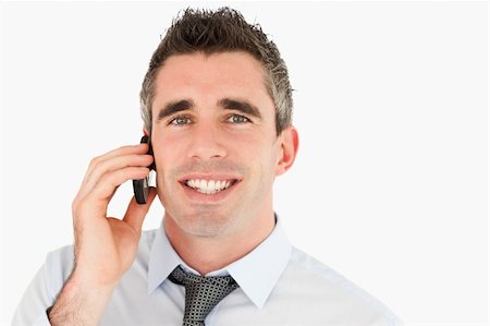 simsearch:400-05145011,k - Close up of a happy businessman making a phone call against a white background Stock Photo - Budget Royalty-Free & Subscription, Code: 400-04918102