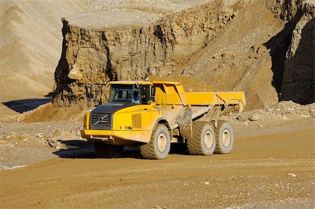simsearch:400-04274028,k - A yellow dump truck is driving in a mine Stock Photo - Budget Royalty-Free & Subscription, Code: 400-04910517