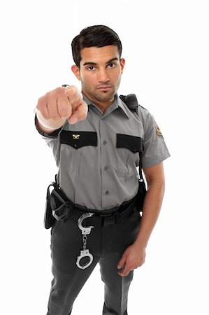 A police officer, prison guard or similar uniformed man stands firm with pointed finger.  Concept Foto de stock - Super Valor sin royalties y Suscripción, Código: 400-04926327