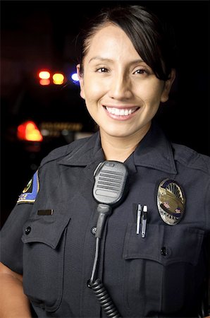 female police officer happy - a female police officer smiling at night with her patrol car in the background. Photographie de stock - Aubaine LD & Abonnement, Code: 400-04920005