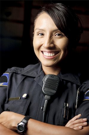 female police officer happy - a female police officer smiling at night and posing for her portrait. Photographie de stock - Aubaine LD & Abonnement, Code: 400-04920003