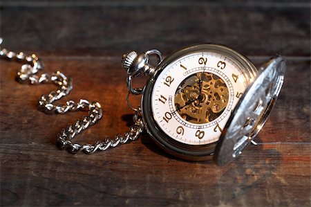 pocket watch - Vintage pocket watch with open lid and chain on wooden surface Stock Photo - Budget Royalty-Free & Subscription, Code: 400-04920155