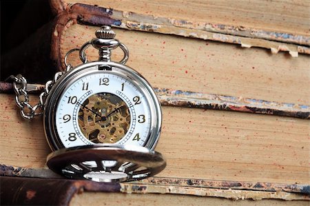 pocket watch - Vintage pocket watch with open lid on background with old books Stock Photo - Budget Royalty-Free & Subscription, Code: 400-04920156
