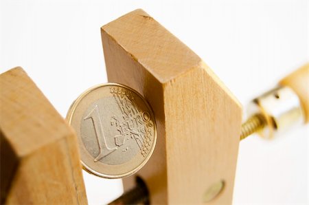 One euro coin under pressure in  a wooden clamp Stock Photo - Budget Royalty-Free & Subscription, Code: 400-04920169