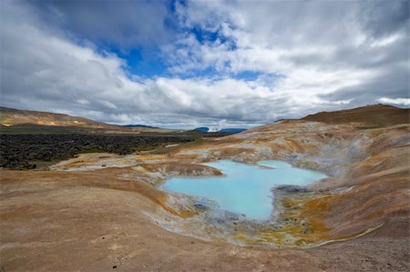 A turquoise lake in a caldera of the Krafla volcanic system, with the lava fields and geothermal activity and its mudpools in the Myvatn region, Iceland Stock Photo - Budget Royalty-Free & Subscription, Code: 400-04923468