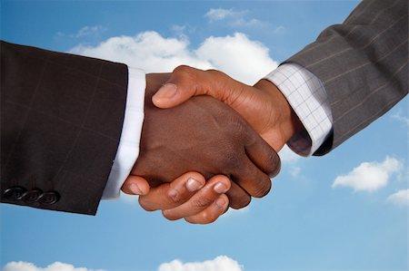 simsearch:400-04434336,k - This is an image of two business hands performing a handshake, with a cloud background. Stock Photo - Budget Royalty-Free & Subscription, Code: 400-04932217