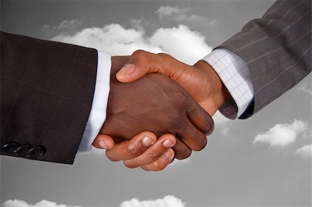 simsearch:400-04434336,k - This is an image of two business hands performing a handshake, with a cloud background. Stock Photo - Budget Royalty-Free & Subscription, Code: 400-04932218