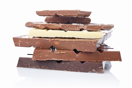 simsearch:400-05136453,k - Blocks of chocolate reflected on white background. Shallow DOF Stock Photo - Budget Royalty-Free & Subscription, Code: 400-04948124