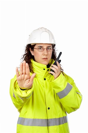 Serious female construction worker talking with a walkie talkie and orders to stop. Hand on focus Stock Photo - Budget Royalty-Free & Subscription, Code: 400-04942327