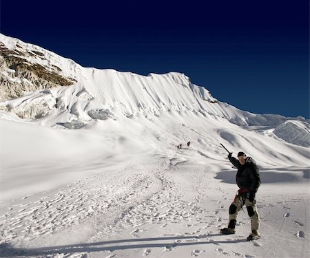 simsearch:400-05118687,k - Mountaineer point out the route to climb Island Peak in Nepal. There are an additional 11 mountaineers in the photo. Stock Photo - Budget Royalty-Free & Subscription, Code: 400-04942671