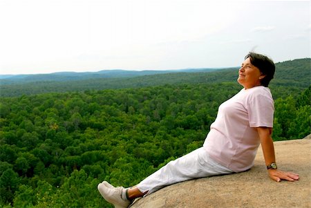 person sitting cliff edge - Mature woman sitting on cliff edge enjoying scenery Stock Photo - Budget Royalty-Free & Subscription, Code: 400-04943020