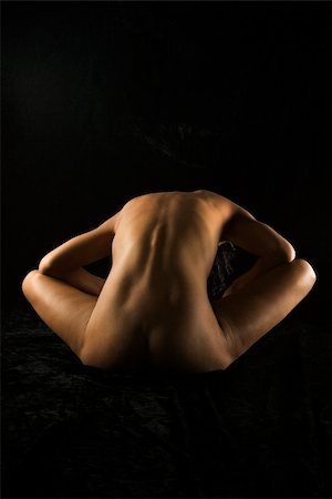 simsearch:400-04450916,k - Back view of nude Hispanic mid adult woman bent over sitting with elbows on knees. Stock Photo - Budget Royalty-Free & Subscription, Code: 400-04955635
