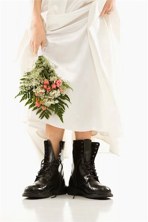 Caucasian bride holding bouquet down by her black combat boots. Stock Photo - Budget Royalty-Free & Subscription, Code: 400-04950356