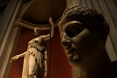 Close-up of head of sculpture with figure sculpture in background in the Vatican Museum, Rome, Italy. Stock Photo - Budget Royalty-Free & Subscription, Code: 400-04953982