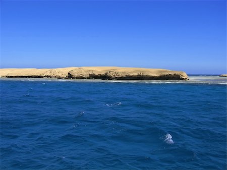 The sandy island located at ocean, among small waves Stock Photo - Budget Royalty-Free & Subscription, Code: 400-04967975