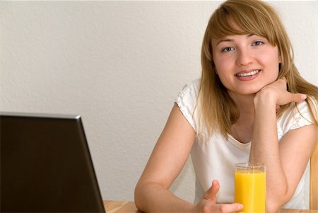 simsearch:400-04559945,k - young  woman working with laptop and drinking orange juice Photographie de stock - Aubaine LD & Abonnement, Code: 400-04979013