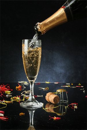 Pouring a champagne flute for celebration time (with confetti) Stock Photo - Budget Royalty-Free & Subscription, Code: 400-04979776