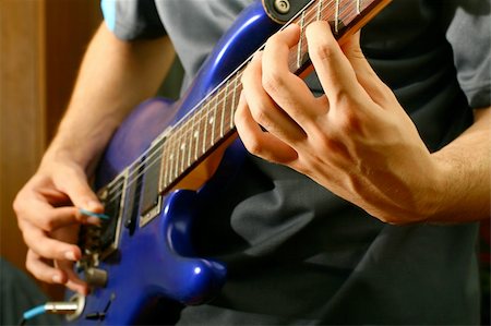 picture of the blue playing a instruments - man play solo on blue guitar Stock Photo - Budget Royalty-Free & Subscription, Code: 400-04985355