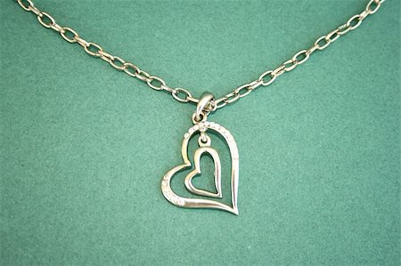 Two hearts with stones and necklace isolated on the green. Foto de stock - Super Valor sin royalties y Suscripción, Código: 400-04986910