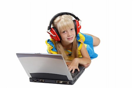 simsearch:400-05717451,k - The girl with headphones lays before a portable computer on a white background Stock Photo - Budget Royalty-Free & Subscription, Code: 400-04989414