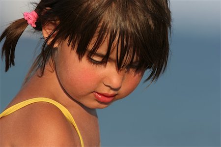 Face of a little girl looking downwards, with sand on her face. Stock Photo - Budget Royalty-Free & Subscription, Code: 400-04980843