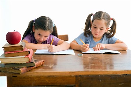 simsearch:400-08315791,k - two girl pupil sitting by the table with globe and red apple on a pile of books, Isolated on white Foto de stock - Super Valor sin royalties y Suscripción, Código: 400-04982096