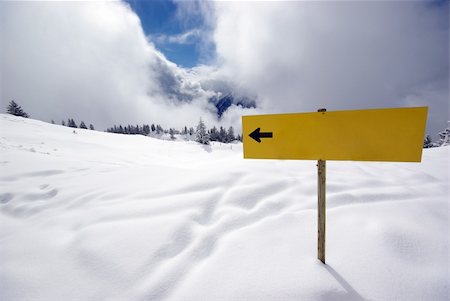 simsearch:400-03985663,k - Mountain panorama during sunny day in Alps with yellow sign showing which way shoul You go Stock Photo - Budget Royalty-Free & Subscription, Code: 400-04994798