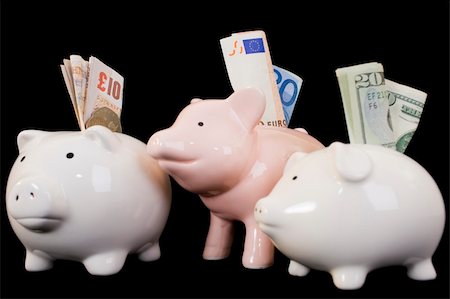 simsearch:400-06077471,k - Piggybank with various international currencies on a black background. Conceptual shot showing Euro, Dollar and Sterling, indicating the weakness of the Dollar. Stock Photo - Budget Royalty-Free & Subscription, Code: 400-05008204