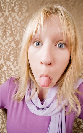 Pretty young girl sticking out her tongue Stock Photo - Budget Royalty-Free & Subscription, Code: 400-05000165