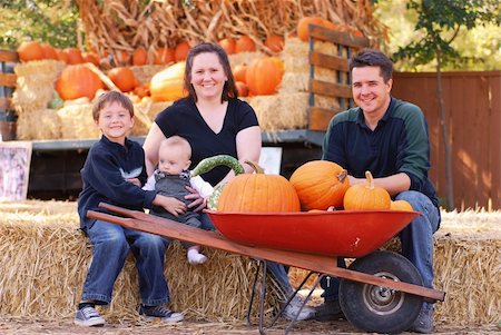 Portrait of a family of four at a pumpkin patch in autumn Stock Photo - Budget Royalty-Free & Subscription, Code: 400-05002232