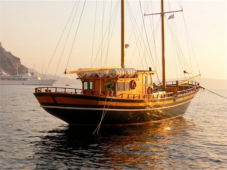 simsearch:400-04433053,k - An sailboat made from wood in the sunset on the Greek island of santorini. Stock Photo - Budget Royalty-Free & Subscription, Code: 400-05015823