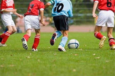 Detail of a soccer game with four players in action Stock Photo - Budget Royalty-Free & Subscription, Code: 400-05017218