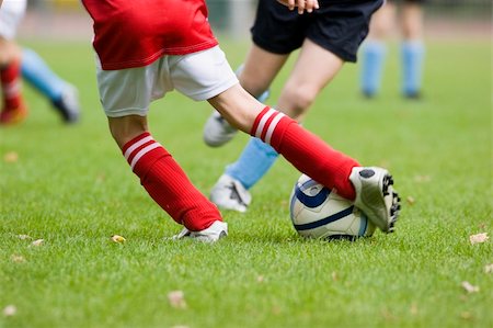 Detail of a football match - focus on the feet and the football Stock Photo - Budget Royalty-Free & Subscription, Code: 400-05017230