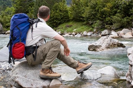 simsearch:632-05604251,k - Hiker with backpack resting at a mountain river Photographie de stock - Aubaine LD & Abonnement, Code: 400-05018082
