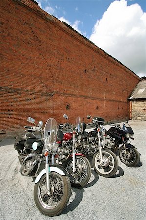 simsearch:400-05017762,k - Motorcycles at a brick wall on a background of the sky Stock Photo - Budget Royalty-Free & Subscription, Code: 400-05018256