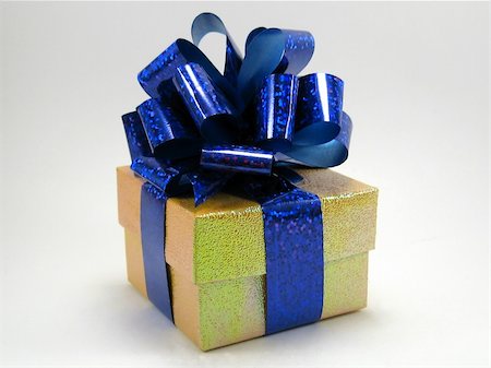 Gift in a yellow box with a  blue bow on a white background Stock Photo - Budget Royalty-Free & Subscription, Code: 400-05010966