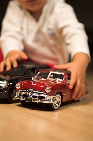little boy playing indoor with model cars Stock Photo - Budget Royalty-Free & Subscription, Code: 400-05011590