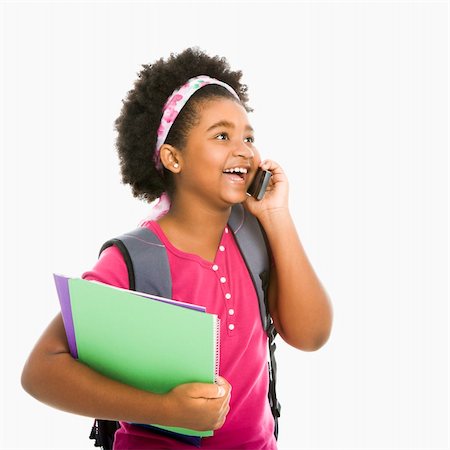simsearch:400-05012508,k - African American girl with books and wearing backpack talking on cell phone. Foto de stock - Super Valor sin royalties y Suscripción, Código: 400-05012505