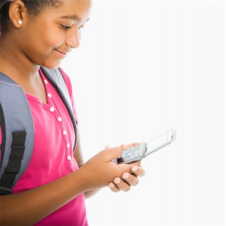 simsearch:400-05012508,k - African American girl with backpack text messaging on cell phone. Foto de stock - Super Valor sin royalties y Suscripción, Código: 400-05012506