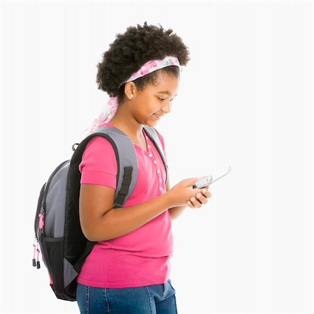 simsearch:400-05012508,k - African American girl with backpack text messaging on cell phone. Foto de stock - Super Valor sin royalties y Suscripción, Código: 400-05012507