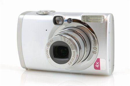 simsearch:400-04294580,k - Digital camera with reflection in isolated white background Stock Photo - Budget Royalty-Free & Subscription, Code: 400-05024336