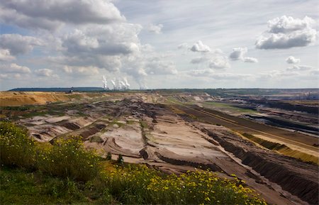 Open-pit mining for lignite (brown coal) that is burnt and transformed to electricity by the power station at the horizon - largest mining sites and power production site in Germany Stock Photo - Budget Royalty-Free & Subscription, Code: 400-05027569