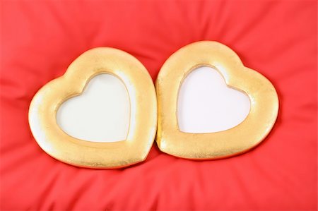 simsearch:400-05897213,k - two gold hearts are situated on red pillow Stock Photo - Budget Royalty-Free & Subscription, Code: 400-05027646