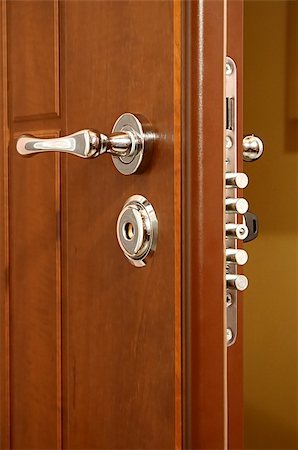 simsearch:400-04617631,k - The modern and safe lock on a wooden door Stock Photo - Budget Royalty-Free & Subscription, Code: 400-05028104