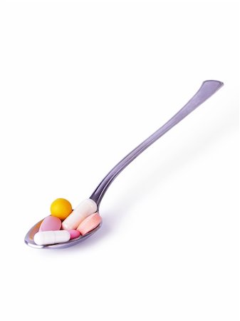 simsearch:400-04000864,k - Yellow, white and pink colored pills in a spoon on a white background Stock Photo - Budget Royalty-Free & Subscription, Code: 400-05029044