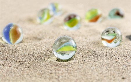 playground retro - glass marbles on sand Stock Photo - Budget Royalty-Free & Subscription, Code: 400-05029553